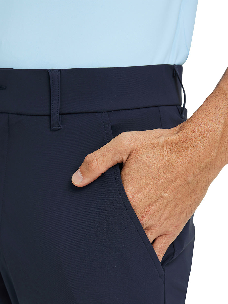 Close-up detail of one hand resting in pocket, showing relaxed fit of the navy quick dry pants.