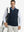 Model carrying golf bag, styled in navy print collar quarter zip golf vest, relaxed sporty fit.