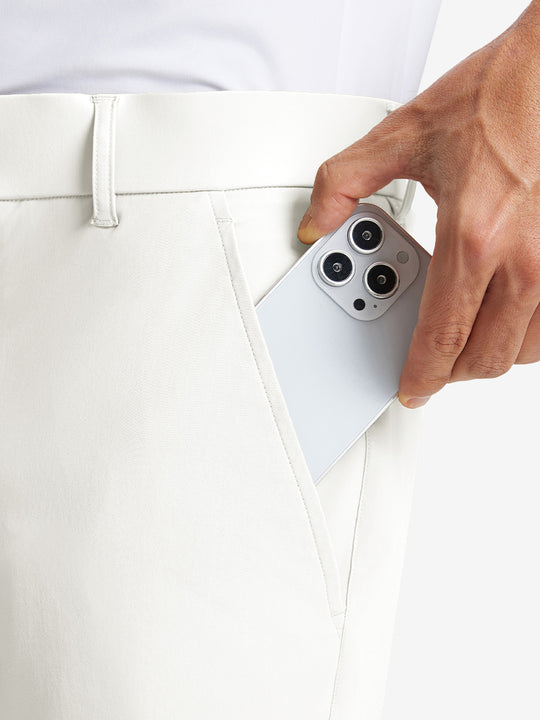 iPhone placed inside pocket of the White Quick Dry Casual Shorts, showing storage space.