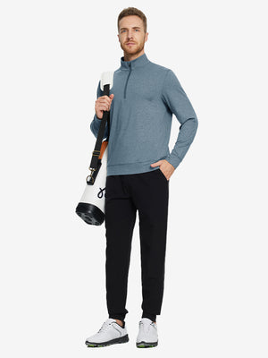 Full-body view of model carrying golf bag in quarter zip melange pullover saxony blue melange.