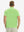Back half-body view of model wearing the turquoise green ventilated pique performance polo, highlighting the rear silhouette