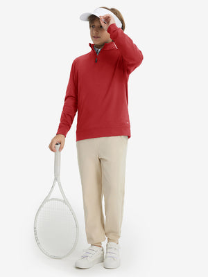 Model wearing a cap and holding a tennis racket, youth winter micro-fleece quarter zip pullover in red