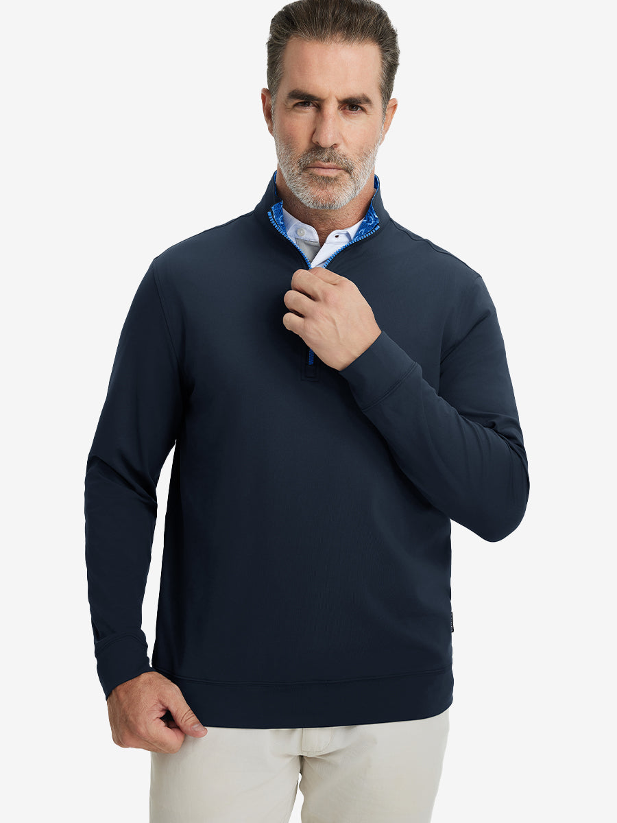 Front upper body view of model wearing lightweight golf quarter zip pullover in navy, relaxed fit.