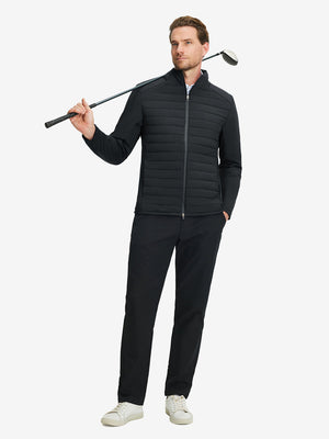 Front full body shot of model wearing black warm puffer winter golf jacket with golf club resting on shoulder