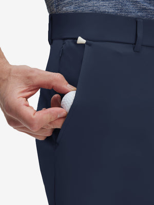 Detail view of front pocket on navy flat front golf joggers pants with belt loops