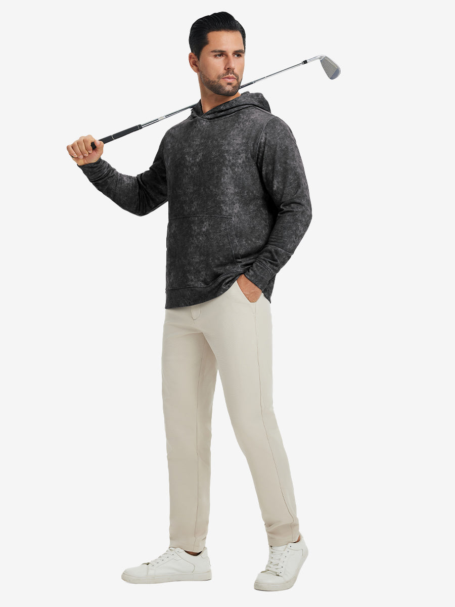 Full-body view of model in black exclusive print kangaroo hoodies holding a golf club outdoors.