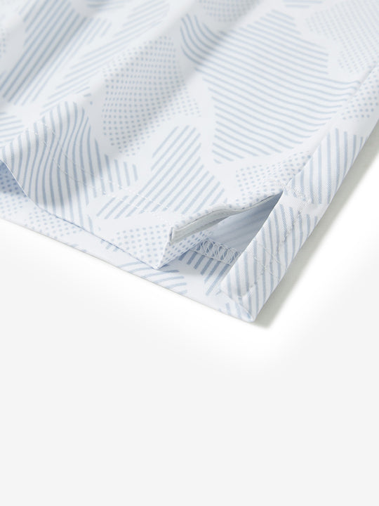 Hem slit detail of the light gray irregular pattern lightweight print long sleeve polo, showing fine stitching and finish.