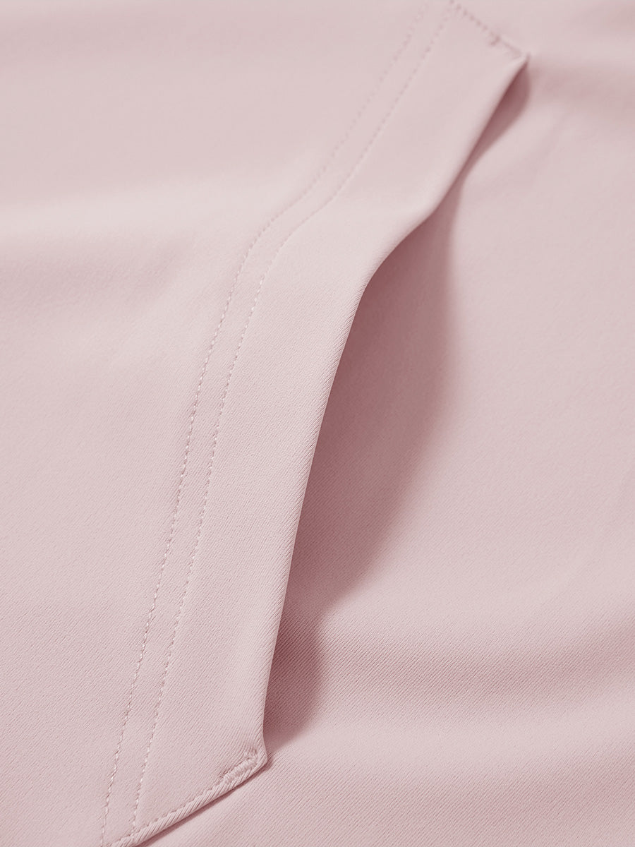 Close-up of single pocket detail on youth long sleeve hoodied with kangaroo pocket in light pink, showing stitching.