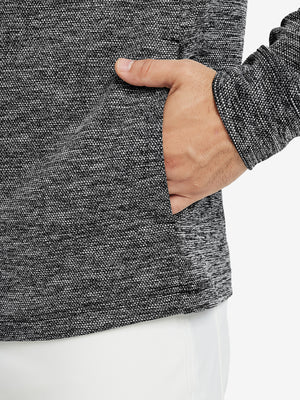 Close-up of pocket detail, single hand inside texture solid hoodies pullover, casual style in black heather.