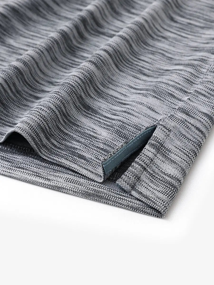 Close-up of hem slit detail on DARK GREYBLACK HEATHER Cool Heather Texture Polo