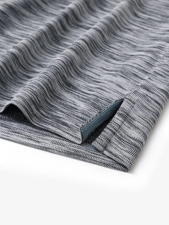 Close-up of hem slit detail on DARK GREYBLACK HEATHER Cool Heather Texture Polo