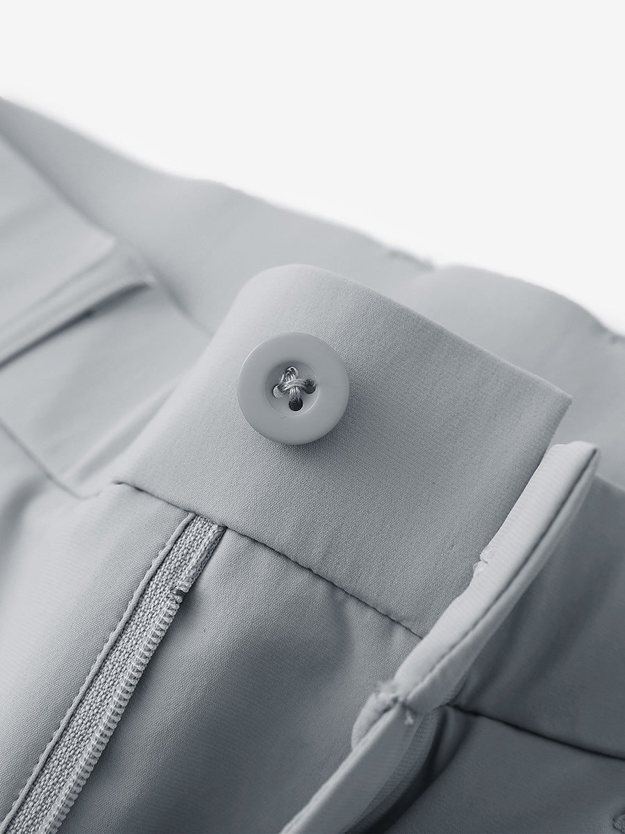 Waist detail of quick dry casual dress pants in light grey, featuring button and zipper design.
