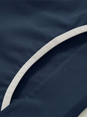 Side pocket detail of the mock neck quarter button golf pullover in navy, practical design feature.