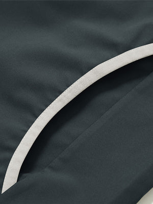 Side pocket detail of the mock neck quarter button golf pullover in dark grey, practical design feature.