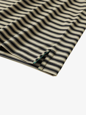 Close-up of the hem slit on the Black Khaki Yarn Dyed Stripe Polo – tailored for comfort and mobility