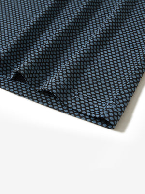 Hem detail of jacquard quarter zip pullover in black/blue, focusing on stitching and side vent finish.