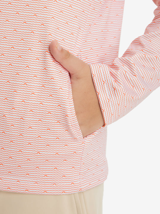 Model with both hands in pockets wearing youth full print stylish hoodies pullover in orange sea wave.