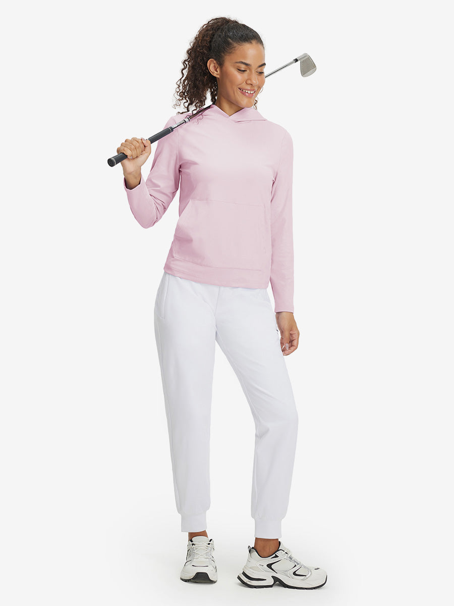 Model holding golf club, dressed in women's lightweight hoodies pullover in pale pink.