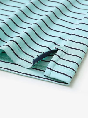 Close-up of side slit hem on TURQUOISE/NAVY STRIPE Polo — clean and breathable finish