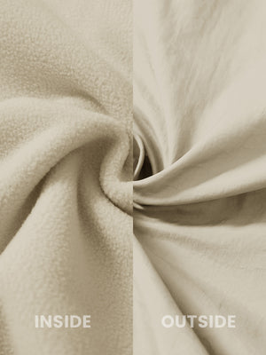 Close-up of the inside-out fabric of the reversible fleece jacket with 5 pockets in khaki.