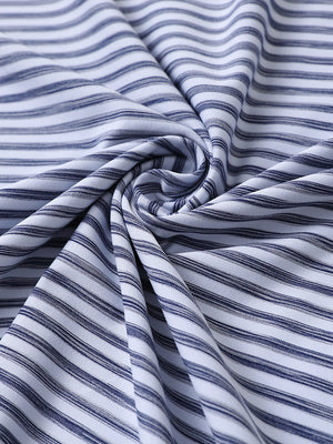Close-up of dark blue white unique watercolour stripe polo fabric showing soft, blended stripes and smooth texture.