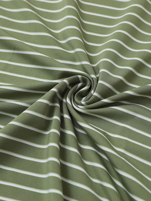 Close-up fabric view of youth performance golf polos, smooth texture with breathable light green/white stripe finish