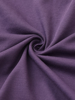 Fabric close-up of purple cotton blend pique plain shirt, breathable pique fabric texture.