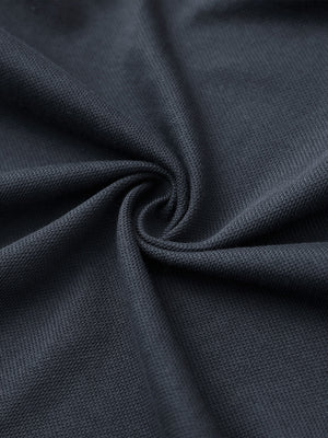 Fabric close-up of dark grey cotton blend pique plain shirt, breathable pique fabric texture.