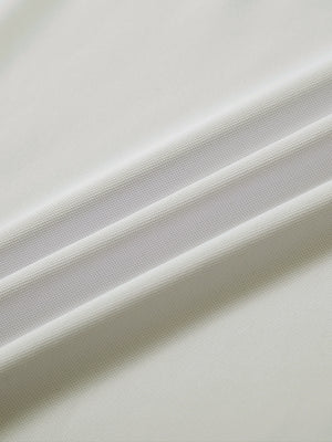 Close-up of cream everyday classic solid polo fabric texture.