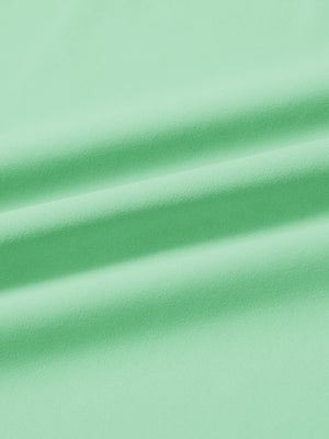 Close-up fabric detail of lightweight golf quarter zip pullover, smooth texture and breathable feel in light green