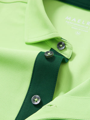 Detail shot of the collar on the turquoise green ventilated pique performance polo, emphasizing the classic neckline design