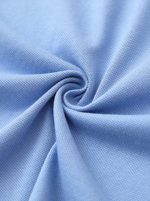 Fabric close-up of light blue cotton blend pique plain shirt, breathable pique fabric texture.