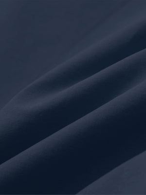 Close-up of navy boys lightweight dry fit flat front golf shorts fabric texture.