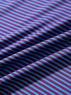 Texture close-up of Kids stripe golf polos with soft fabric and bright plum blue stripe stripes