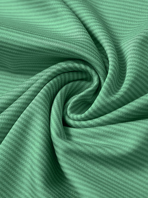 Close-up of green melange pinstripe quarter zip pullover fabric showing fine lines and soft knit texture.