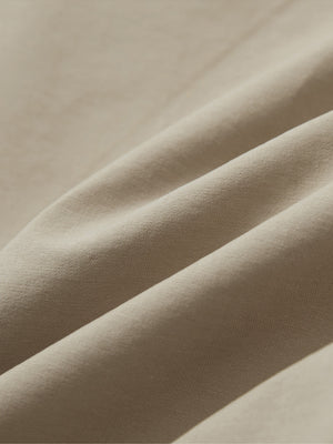 Close-up of khaki grey boys lightweight dry fit flat front golf shorts fabric texture.