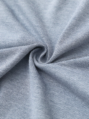 Fabric close-up of dark blue heather cotton blend pique plain shirt, breathable pique fabric texture.