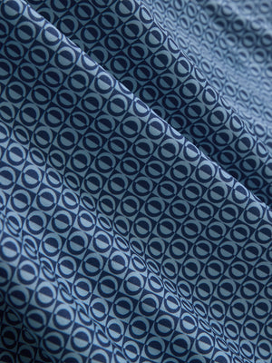 Fabric close-up of Performance quick dry print golf polos showing breathable texture in light blue navy circles