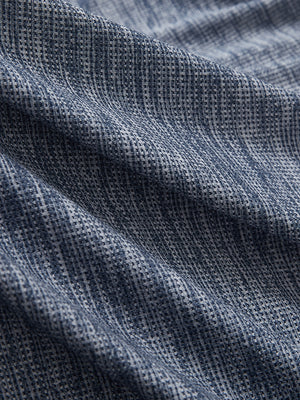 Close-up of misty blue white grid ultra-light quick dry moisture wicking collared polo shirt fabric texture