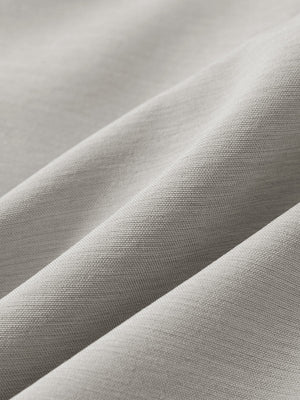 Close-up texture of light gray flat front hybrid golf shorts fabric showing detailed hybrid material and weave.