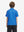 Back half-body view of youth wearing blue swordfish performance print boys golf polo, showing rear design