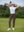 Woman wearing Women's Ultra-stretch Quick Dry Sweatpants with Ankle Zips in coffee brown, holding golf club on course