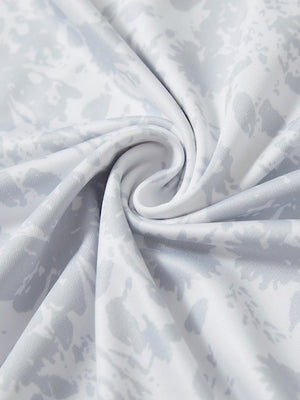 Close-up fabric detail of lightweight print long sleeve polo, breathable texture and soft feel in grey ink splash