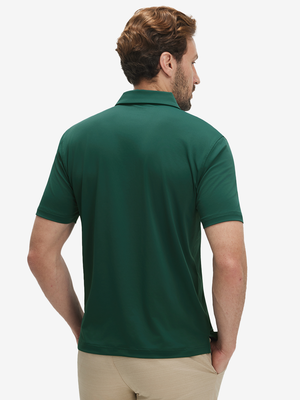Back half-body view of a model wearing the blackish green everyday classic solid polo, highlighting the tailored rear fit