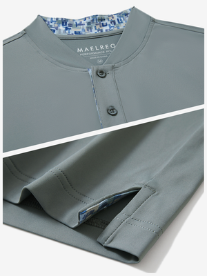 Detail of grey moisture-wicking short sleeve henley shirt showing collar and hem vent construction.