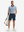 Full front: model in light dark blue graphics lightweight stretch upgraded print golf polo shirts holding golf bag.