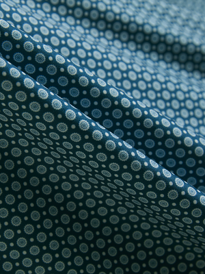 Close-up of blue small flower lightweight stretch upgraded print golf polo shirts, showcasing texture and print details.