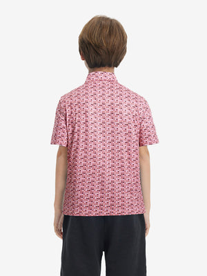Back half-body view of youth wearing pinkdonut performance print boys golf polo, showing rear design
